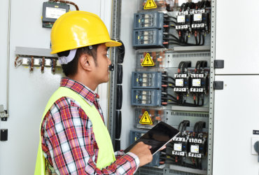 man holding folder in front of the circuit breaker