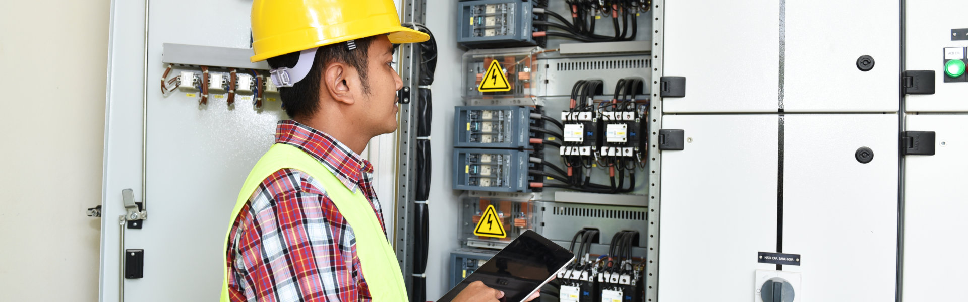 man holding folder in front of the circuit breaker